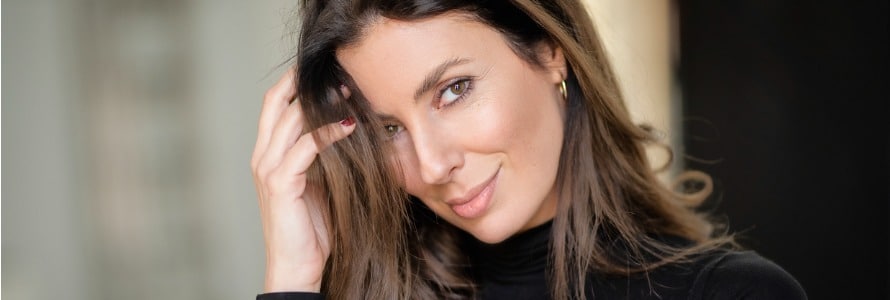 portrait of a beautiful brunette hair woman looking at camera and smiling.